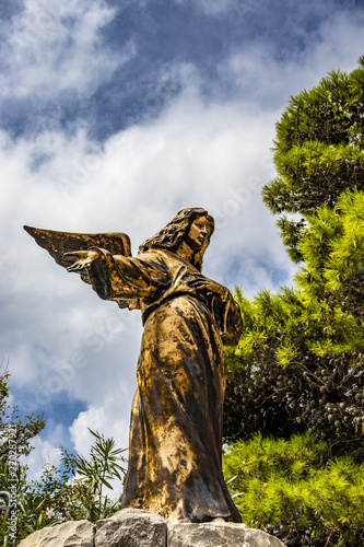 Fotografie, Obraz A bronze statue of an angel in Santa Maria di Leuca