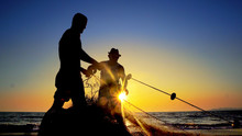 Fishermen Working Repairing Fishing Nets On Ocean Coast At Sunset, Cinematic Shot