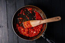 Classic Homemade Tomato Sauce In The Pan On A Wooden Chopping Board On Brown Background, Top View. Pasta, Pizza Tomato Sauce. Vegetarian Food