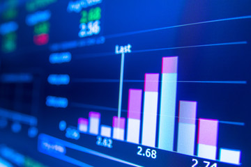 Stock market graph analysis. Stock market data on LED display on laptop screen for finance and economic. Business graph background.