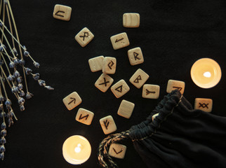 Scandinavian runes. Wooden runes on black background.