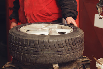 Professional mechanic working on tyre.