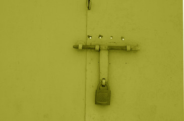 Wall Mural - Old padlock on metal gate in yellow color.