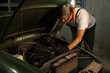 © Wavebreak Media - Male mechanic servicing a car