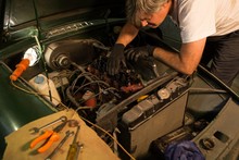 Male Mechanic Servicing A Car