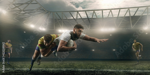 Plakaty Rugby  gracze-rugby-walcza-o-pilke-na-profesjonalnym-stadionie-rugby