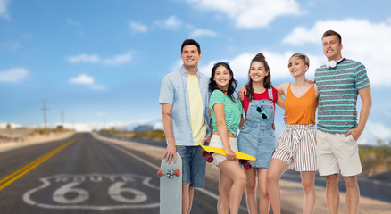 Wall Mural - friendship, extreme sport and people concept - happy friends with skateboards over us route 66 background