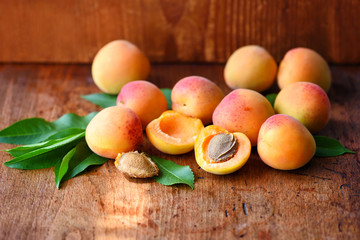 Wall Mural - Ripe apricots on the old wooden background