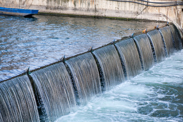 Regulated water flow of and irrigation channel that flows through the middle of a city. The channel flows through a filtering station to provide potable water for the people of the city. No shortage.