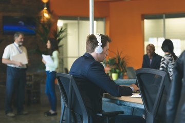 Businessman using laptop at desk 