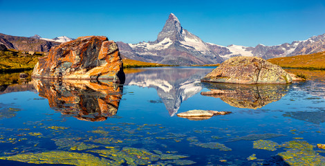 Colorful summer panorama of the Stellisee lake. Great outdoor scene with Matterhorn (Monte Cervino, Mont Cervin) in Swiss Alps, Zermatt location, Valais canton, Switzerland, Europe.