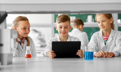 Sticker - education, science and technology concept - kids with tablet pc computer studying chemistry at school laboratory