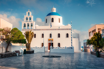 Sunny morning view of Santorini island. Picturesque spring sc ene of the famous Greek resort Oia, Greece, Europe. Traveling concept background. Artistic style post processed photo.