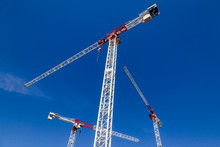 Tower Cranes Against The Blue Sky - Construstion Concept
