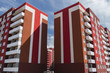 Colorful apartment buildings. Kazakhstan (Ust-Kamenogorsk). Apartment building brightly painted. Building under construction. Red building