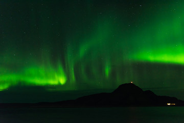 norwegian aurora borealis with mountains and water, view from hurtigruten ship boat, norway, europe,