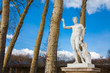 Statue of Apollo with a lyre at the garden of the Versailles Palace in a freezing winter day just before spring