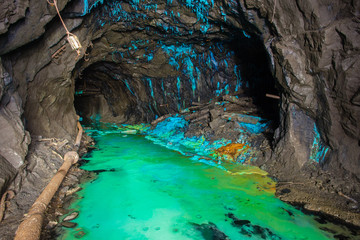 Underground abandoned gold iron ore mine shaft tunnel gallery passage with timbering wooden amazing fantanstic green acid dust