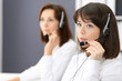 © rogerphoto - Call center. Group of operators at work. Focus on young brunette woman. Business  concept