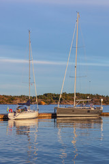 Wall Mural - Picturesque yachts in Risor harbor in the Norwegian Riviera in evening light, Southern Norway