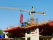 © fotolian121212 - Construction site. Crane near  scaffolding and concrete building.