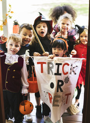 little children trick or treating on halloween