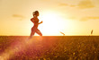 © Boris Riaposov - Sporty woman at sunset in wheat field