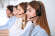 © rogerphoto - Call center. Beautiful cheerful smiling operator consulting clients with headset. Business concept of customer service