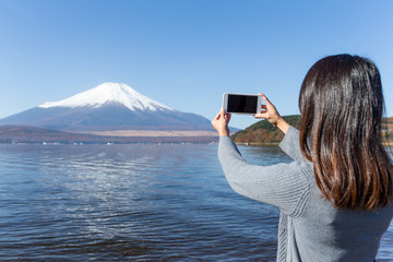 Sticker - Woman take photo by mobile phone of Mount Fuji