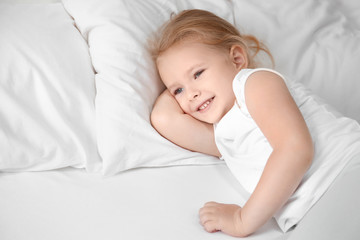 Wall Mural - Little girl lying on white pillow at home