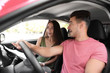 © New Africa - Young couple with map in car on road trip