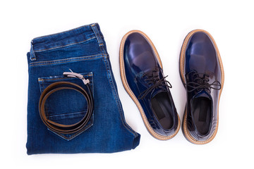 Canvas Print - Men's jeans, leather belt and a pair of blue glossy shoes isolated on white background