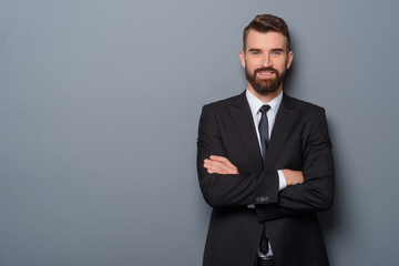 Smiling businessman with crossed arms