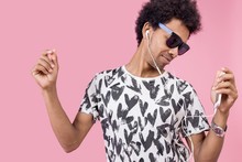 African With Curly Hair In Sunglasses Dancing Listening To Music In Headphones