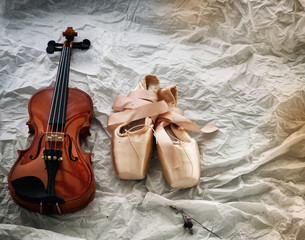 The abstract art design background of violin and ballet shoes put on background,vintage and art style,classice old film tone,blurry light around.