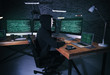 © Africa Studio - Masked hacker using computer in dark room. Threat of cyber attack