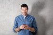 © Africa Studio - Young man in casual clothes using cell phone on light background