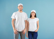 © Africa Studio - Young man and woman in stylish white t-shirts on color background. Mockup for design