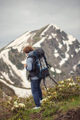 Wall Mural - full length back view photo. resting mountaineer with backpack. leisure activity concept