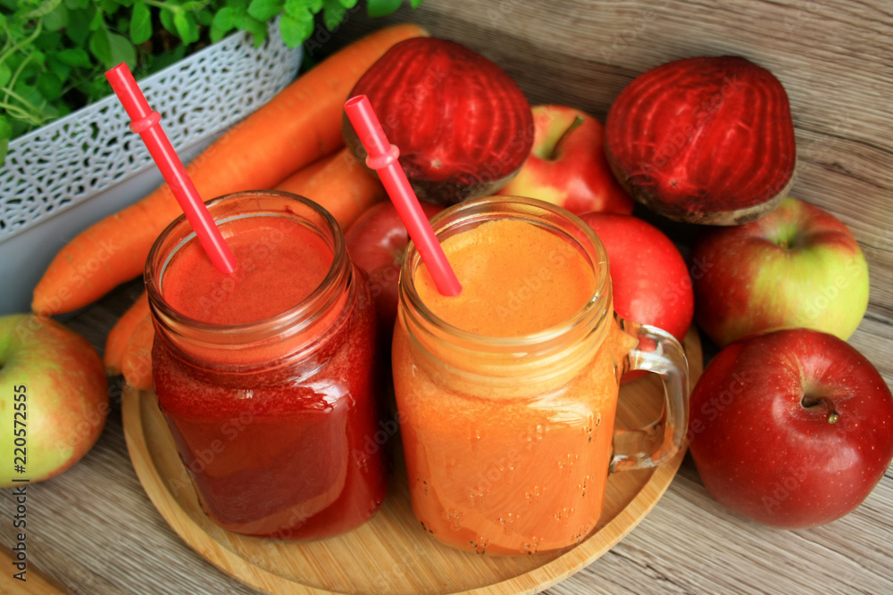 Obraz na płótnie Soki z marchwi, jabłka i buraka, w tle owoce i warzywa w salonie