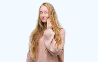 Poster - Blonde teenager woman wearing pink sweater touching mouth with hand with painful expression because of toothache or dental illness on teeth. Dentist concept.