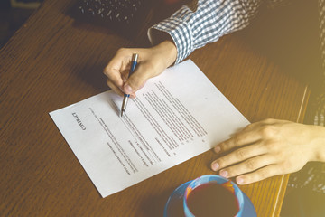 contract document, two men sign paper in the office a toned faded image