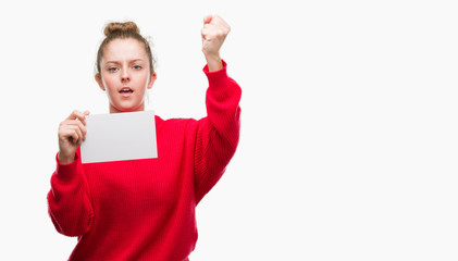 Poster - Young blonde woman holding advertising banner annoyed and frustrated shouting with anger, crazy and yelling with raised hand, anger concept