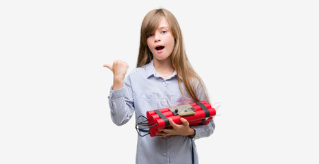 Sticker - Young blonde child holding dynamite bomb pointing with hand and finger up with happy face smiling