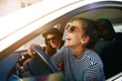 © Flamingo Images - Carefree young friends driving together in a car laughing