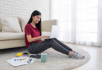 Poster - asian woman freelance working on laptop with paperwork at home,work at home concept.online learning concept.
