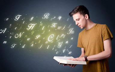 Sticker - Casual young man holding book with shiny letters flying out of it