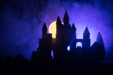 Mysterious Medieval Castle In A Misty Full Moon. Abandoned Gothic Style Old Castle At Night