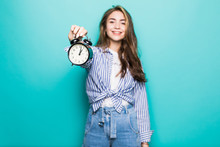 Young Beauty Woman Dressed Holding Alarm Clock Isolated On Blue Background