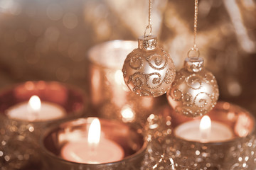 elegant christmas bauble decoration and candles copper colored, perfect for christmas cards and holi